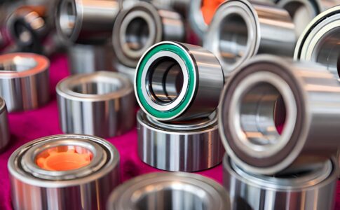 Close-up view of an industrial bearing showing metal components, lubrication, and smooth rotation in machinery