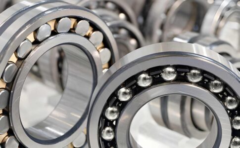Industrial machinery maintenance concept showing bearings and spare parts used in smart planning to reduce machine downtime and improve efficiency.