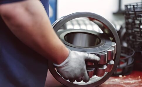 Industrial bearings made from different materials used in machinery under varying conditions like heat, load, and corrosion.